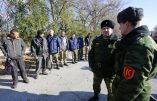 Pro-Russian rebels guard captives, Ukrainian servicemen, prior to their exchange in the small Ukrainian town of Schastya, Lugansk region on October 29, 2015. Ukrainian armed forces and pro-Russian insurgents on Thursday exchanged 20 prisoners in a goodwill gesture designed to get peace talks in the 18-month crisis back on track. The swap took weeks to organise and was the first of its kind since September 8. The pro-Russian eastern militia handed over eight Ukrainian soldiers and one civilian in neutral territory in the predominantly separatist Lugansk province under the watchful eye of observers from the  Red Cross. AFP PHOTO / ALEKSEY FILIPPOV